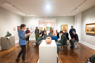 People in a gallery room attending a talk