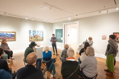 People in a gallery room attending a talk