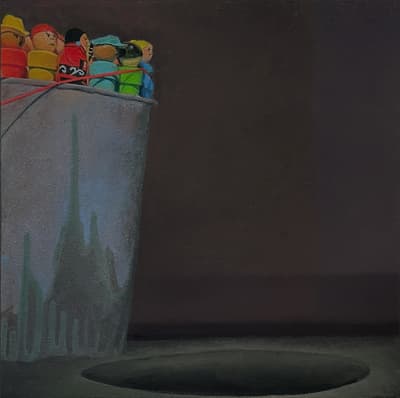 A bucket filled with colorful figurines tied with cords against a dark background.