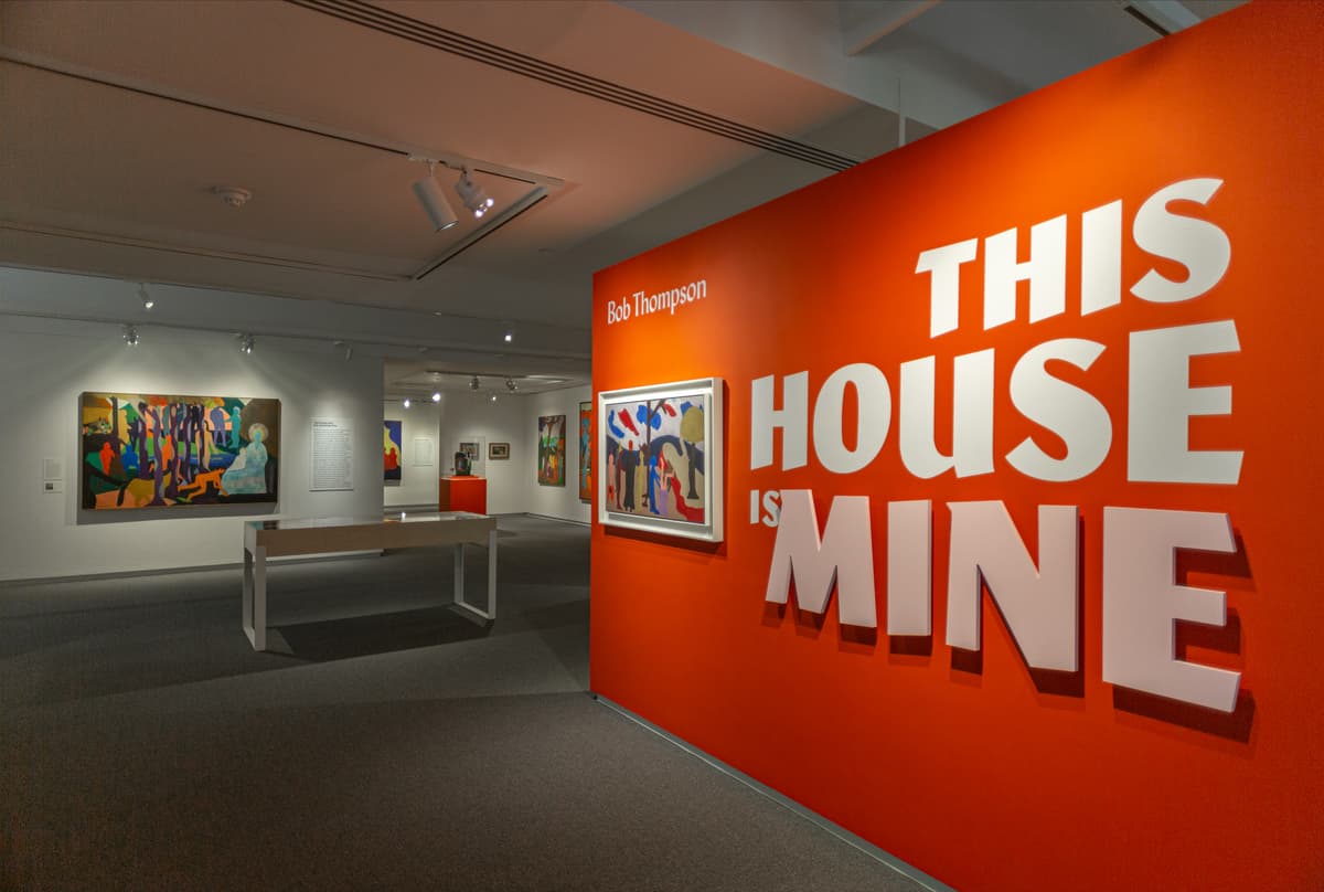 Large orange wall that reads: Instillation view of Bob Thompson: This House is Mine."