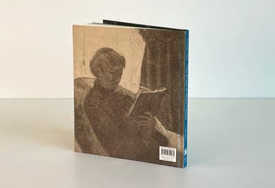 Inside Out: The Prints of Mary Cassatt publication standing on tabletop displaying back cover