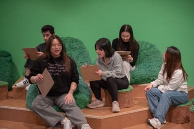 Five students speaking to each other in a gallery