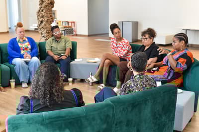 Summer Think Tank participants convening, seated in a circle