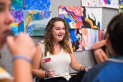 Museum educator leading class visit in studio