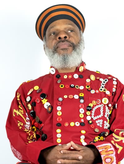 Portrait of Douglas R. Ewart in a read jacket
