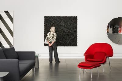 A women looking at a work of art in the Colby Museum lobby.