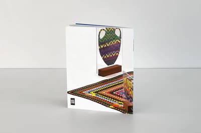 Currents 8: Carly Glovinksi publication standing on tabletop to display back cover