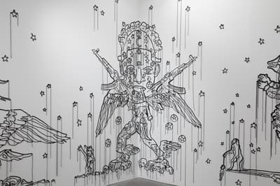 Wall installation made of cord and plastic beads of an angel.