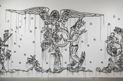 Wall installation made of cord and plastic beads of an angel.