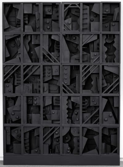A 1979 constructed, wooden sculpture that is painted black by Louise Nevelson.