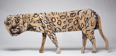 A hand-carved and painted sculpture of a leopard