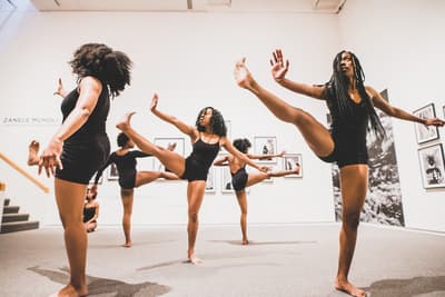 6 dancers performing in an art gallery