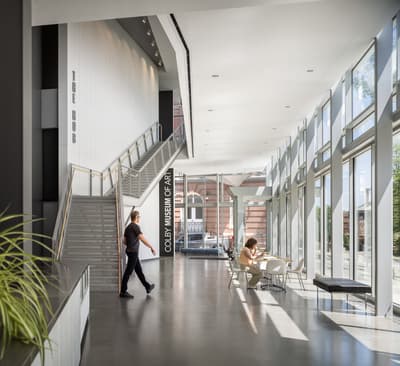 Lobby space of Paul J. Schupf Art Center with visitor passing through.