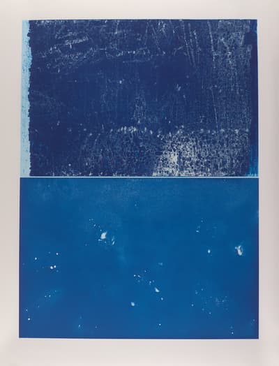 Abstract artwork with a textured dark blue top half and a smooth medium blue bottom half with white specks.