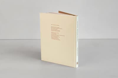 Wiwenikan: the beauty we carry publication standing on tabletop displaying back cover