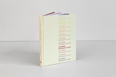 Wiwenikan: the beauty we carry publication standing up on tabletop disaplying front cover