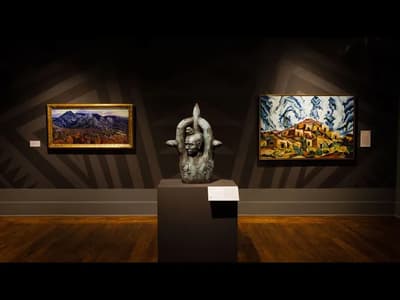 Art gallery with a sculpture and two landscape paintings on display.