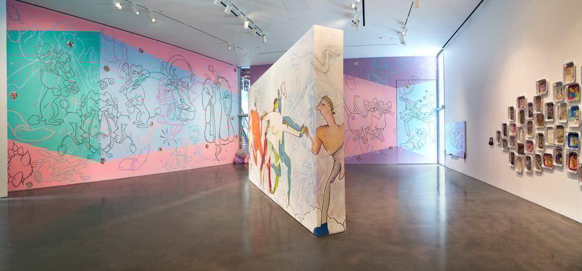 Art gallery with colorful abstract murals on walls and a polished concrete floor.