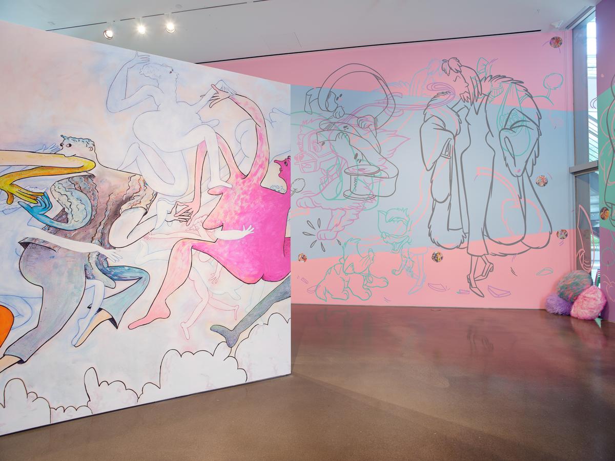 Art gallery with colorful abstract murals on walls and a polished concrete floor.