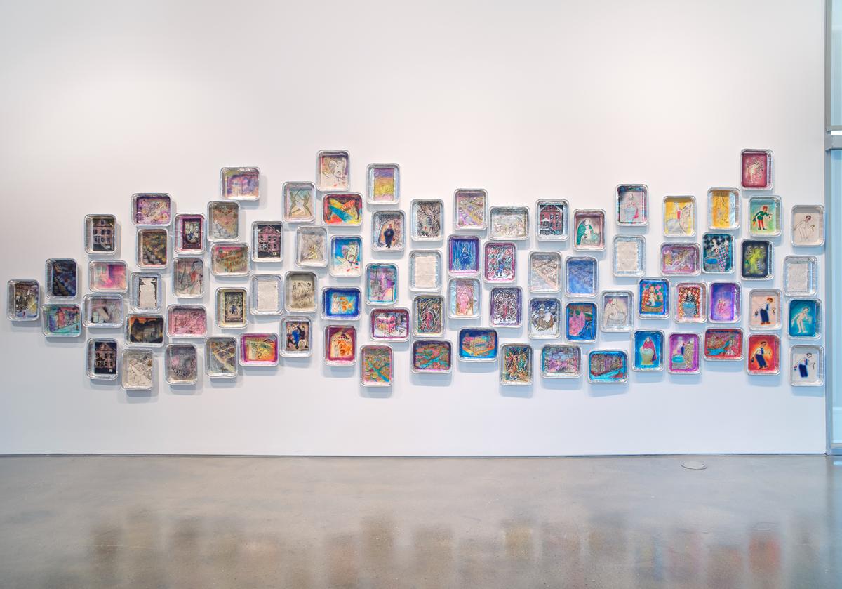 Art gallery with colorful abstract murals on walls and a polished concrete floor.