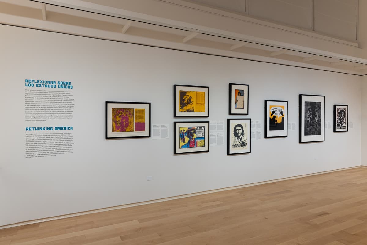 Gallery wall titled “Rethinking America,” featuring eight framed prints with bilingual wall text in English and Spanish