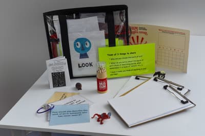 Image of a white tabletop with artmaking tools