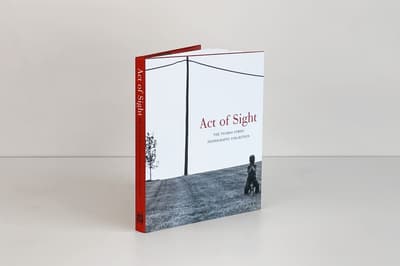 Act of Sight: The Tsiaras Family Photography Collection publication standing up on a tabletop displaying front cover
