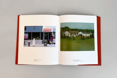 An open book showing a Dunkin' Donuts storefront on one page and a suburban house on the other.