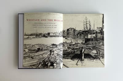 Open book displaying two pages, both with an etching of a dock scene