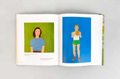 Photograph of the interior of a book with two artworks, one on each page. On the left page, there is a painting of a woman wearing a blue shirt on top of a green background. On the right page, there is a painting of a man wearing green basketball shorts and a white tank top in front of a blue background.