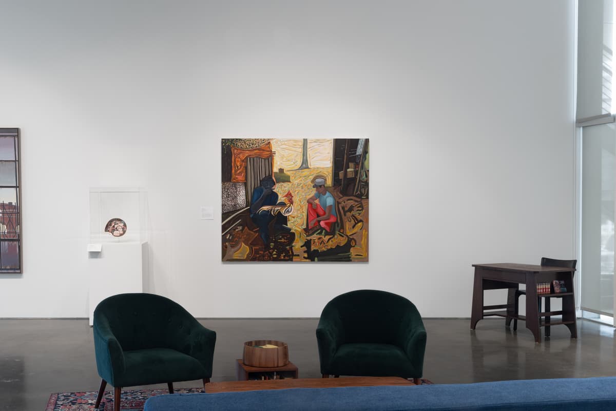 A painting depicting two figures in a vibrant setting, flanked by a display case with a plate, and seating in the foreground