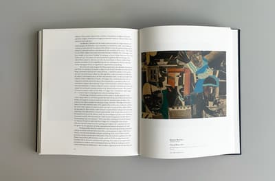 Interior spread of a book. On the right hand page there is an image of a collaged work of art and caption information. On the left hand side there is text.