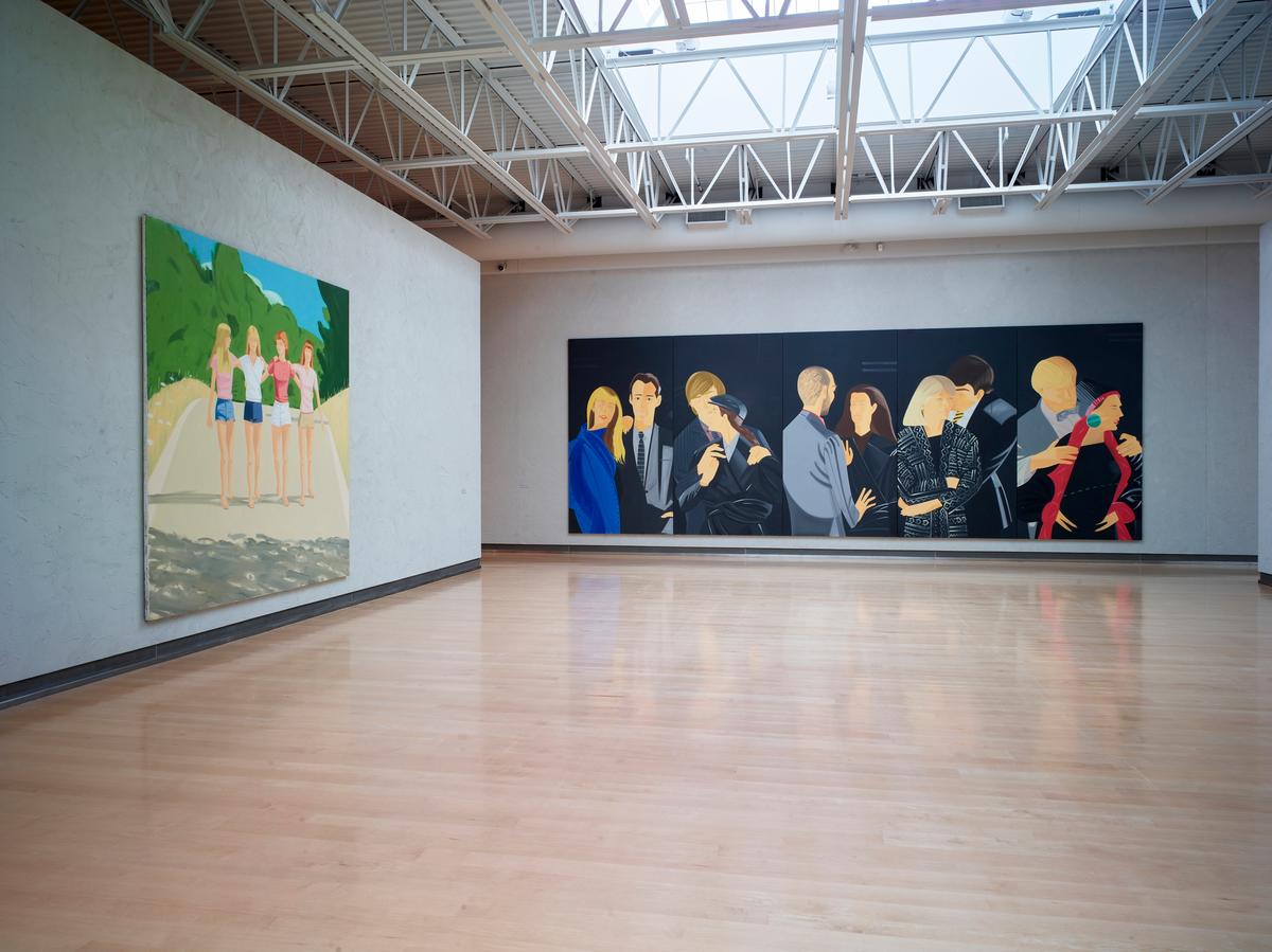 Large paintings on adjacent walls: one of a group of four women walking arm in arm outdoors, the other depicting five panels, each with one male and one female figure.