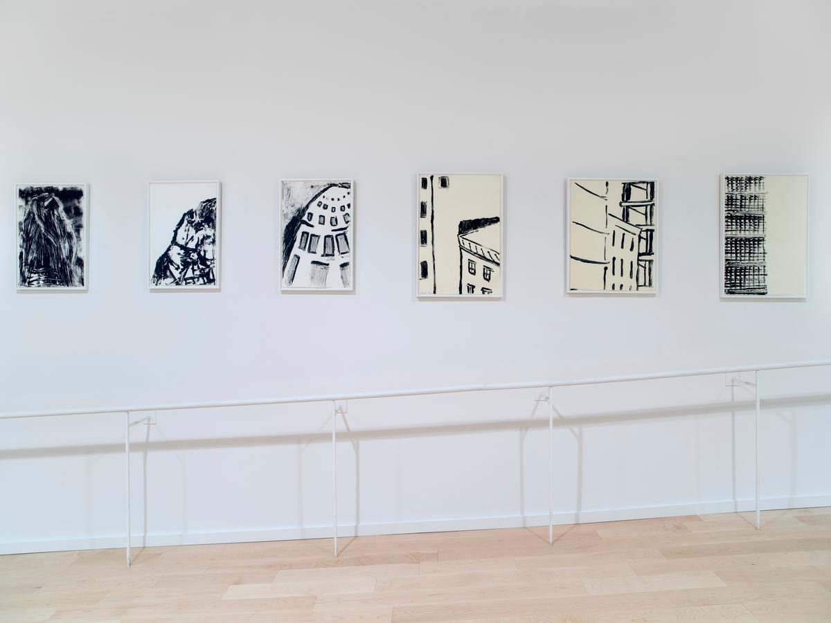 Six framed works installed in a line, each depicting architectural features in black.