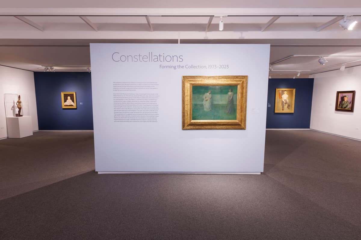 Exhibition title wall reading "Constellations: Forming the Collection, 1973–2023" with a framed painting of two female figures.