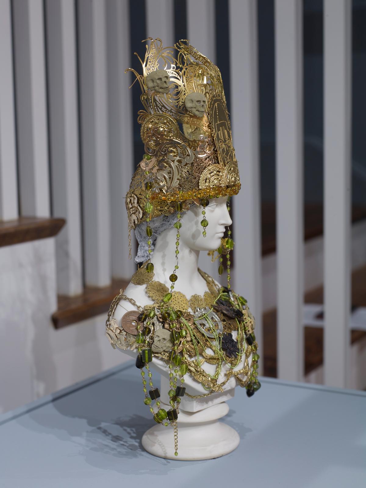 White bust adorned with gold decorative elements and an ornate headdress