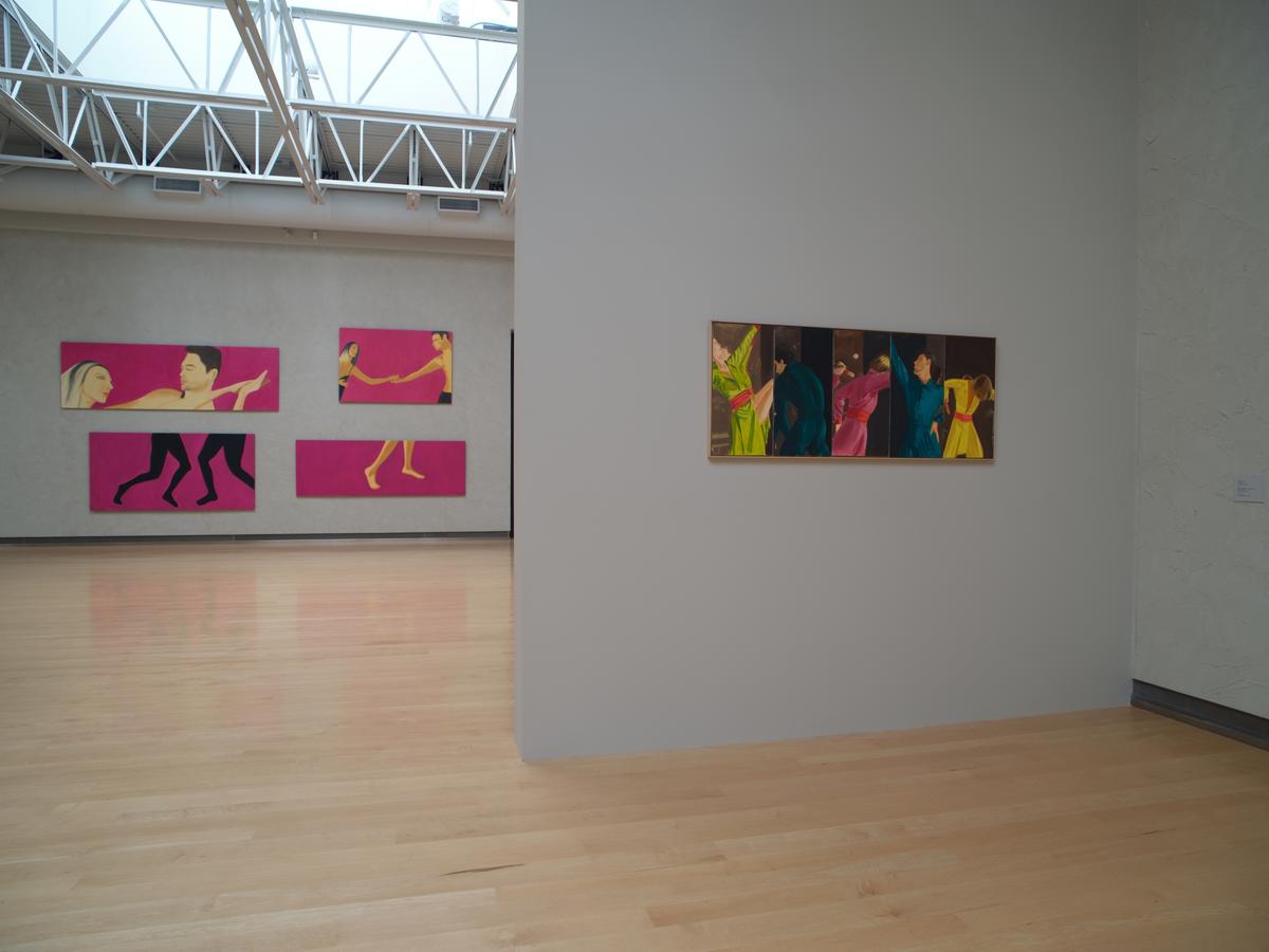 Colorful paintings of figures in motion across two gallery walls.