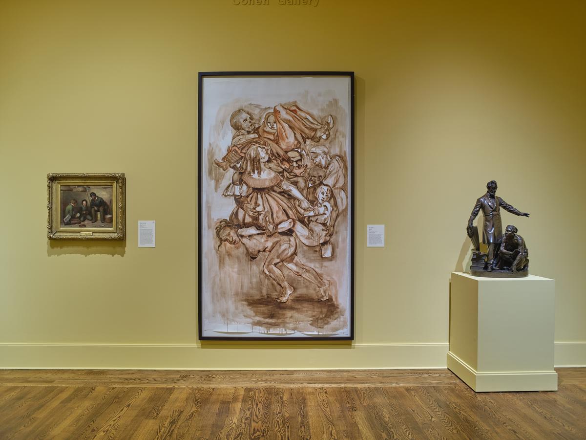 Figurative paintings flanked by a bronze sculpture of two figures on a pedestal