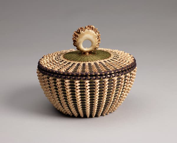Hand-woven basket made from brown ash, sweet grass with an ornamental antler for the pull on the lid.