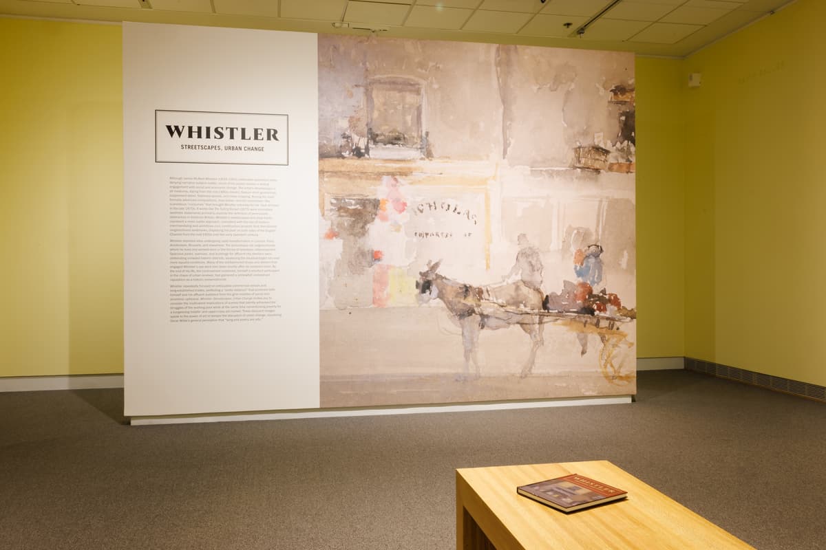 Introductory wall with exhibition text and a large mural of a horse-drawn cart.