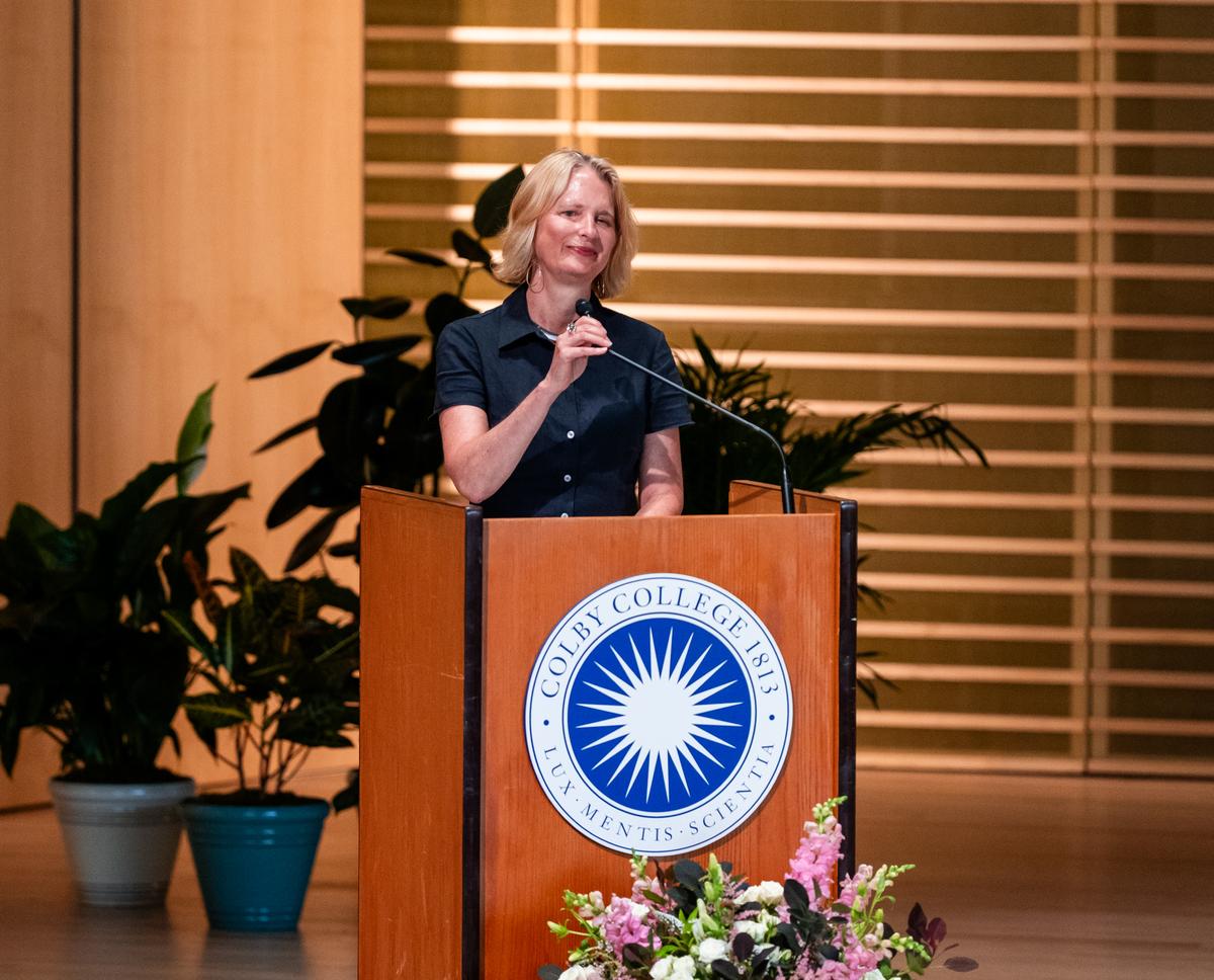 Hilary Barnes Hoopes at a Colby College podium.