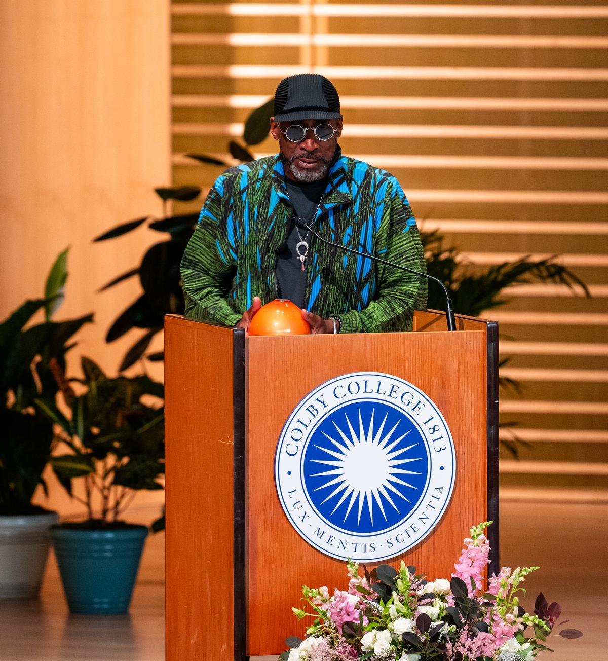 Nari Ward accepting an award at a Colby College podium
