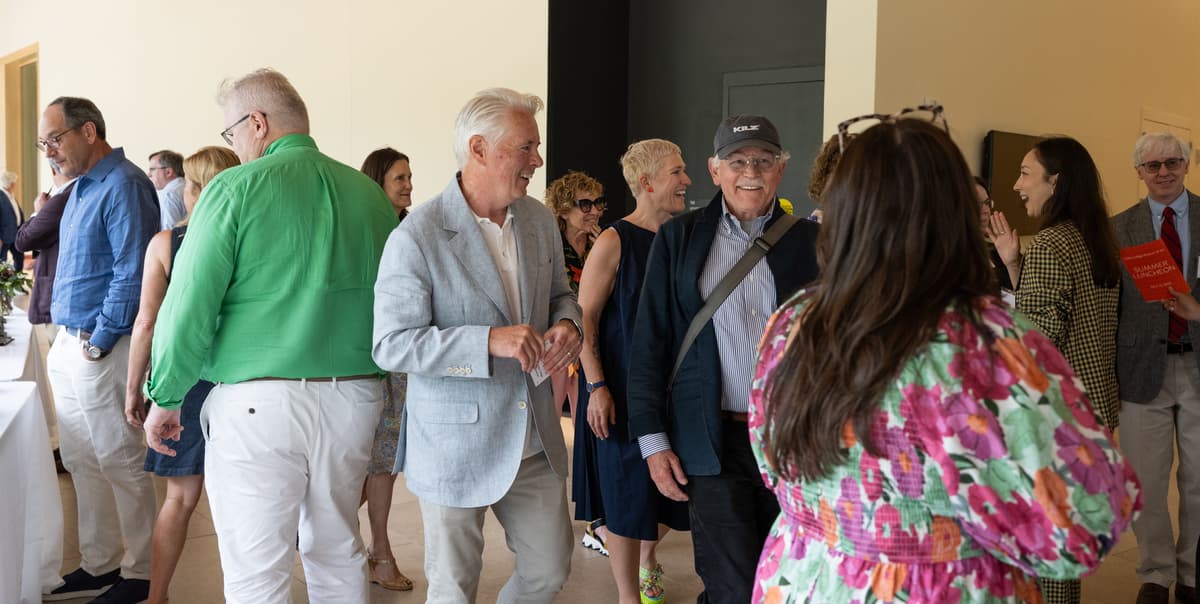 David Greene, and Timothy Stranding talking as they walk through a crowd of people.