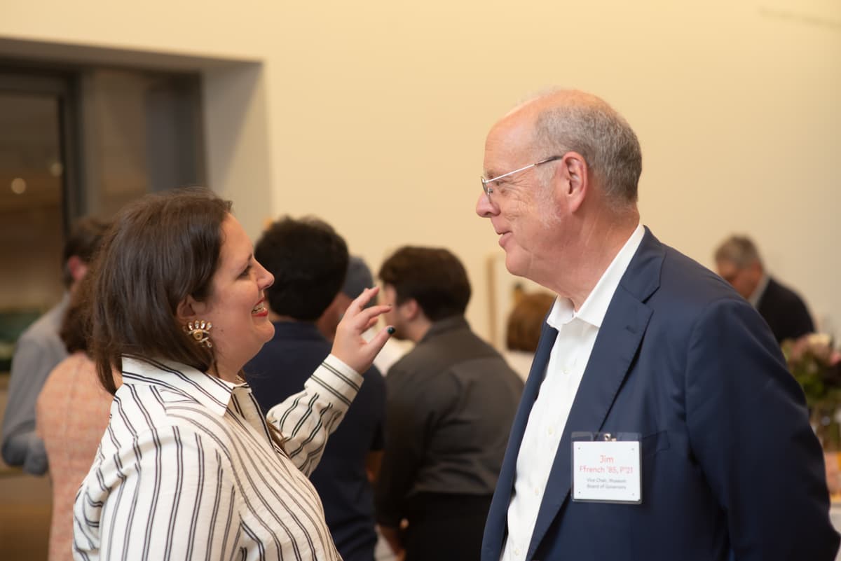Sarah Humphreville and Jim Ffrench speaking to one another in the Colby Museum lobby.