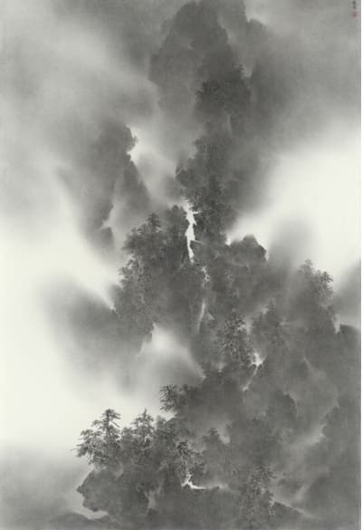 A vertical, monochromatic ink painting in a traditional Chinese style depicts a majestic, misty mountain landscape. Jagged peaks and cliffs emerge from swirling, atmospheric fog, with dark, heavily textured areas suggesting dense forests of pine trees clinging to the slopes, particularly in the lower half and center. The upper portion of the painting is dominated by dark rock forms dissolving into the white mist. The technique uses varying degrees of ink wash, ranging from pale gray to deep black, to create a strong sense of depth, light, and movement of the clouds.
