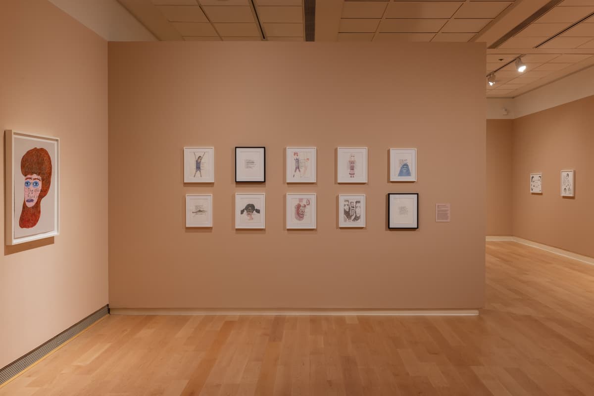 Ten framed drawings how in two rows of five installed in a gallery.