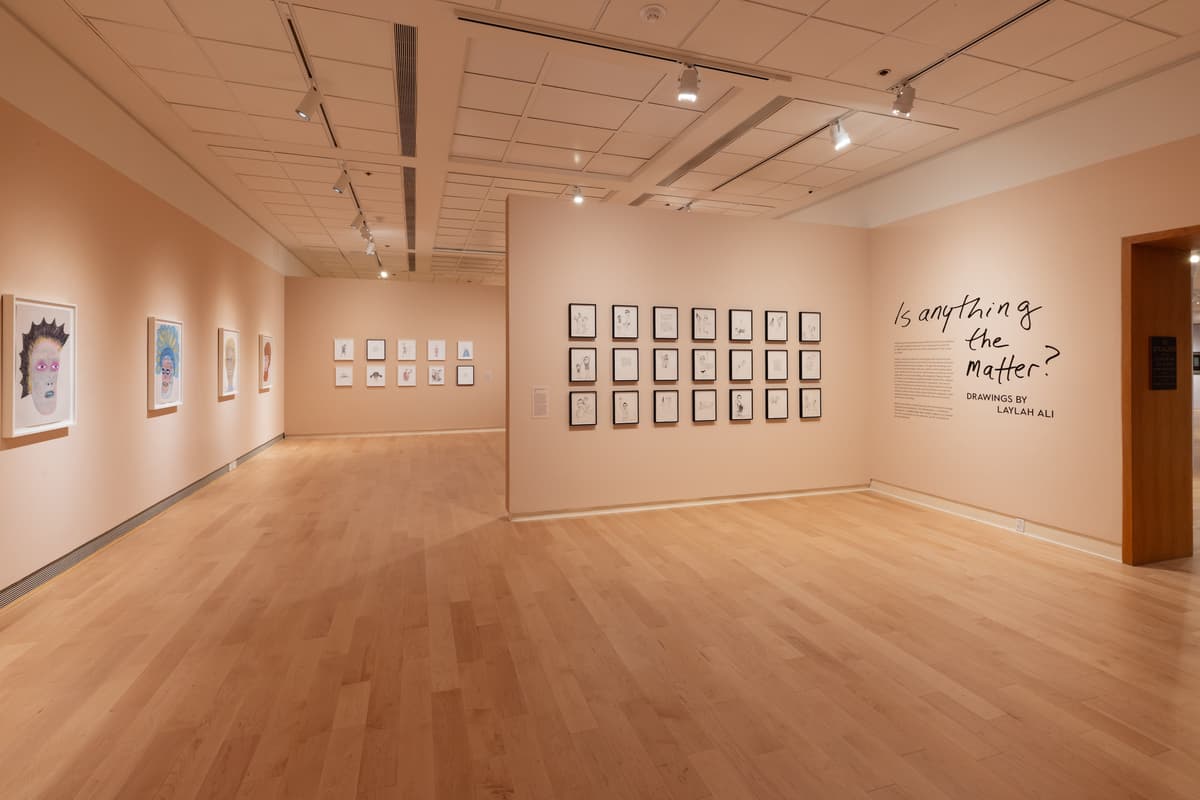 Installation view of gallery hung with framed drawings.