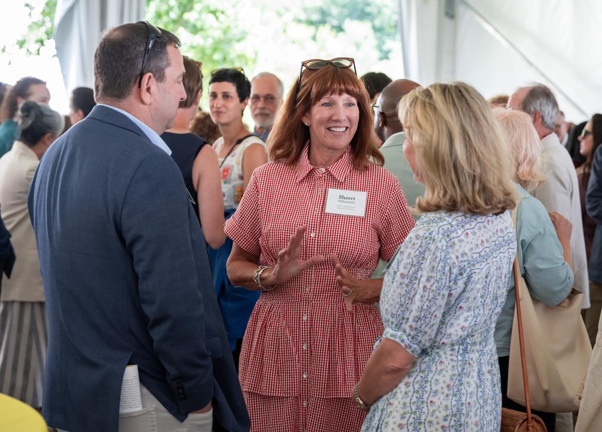 Sherri Athanasia in conversation with guests at the Summer Luncheon.