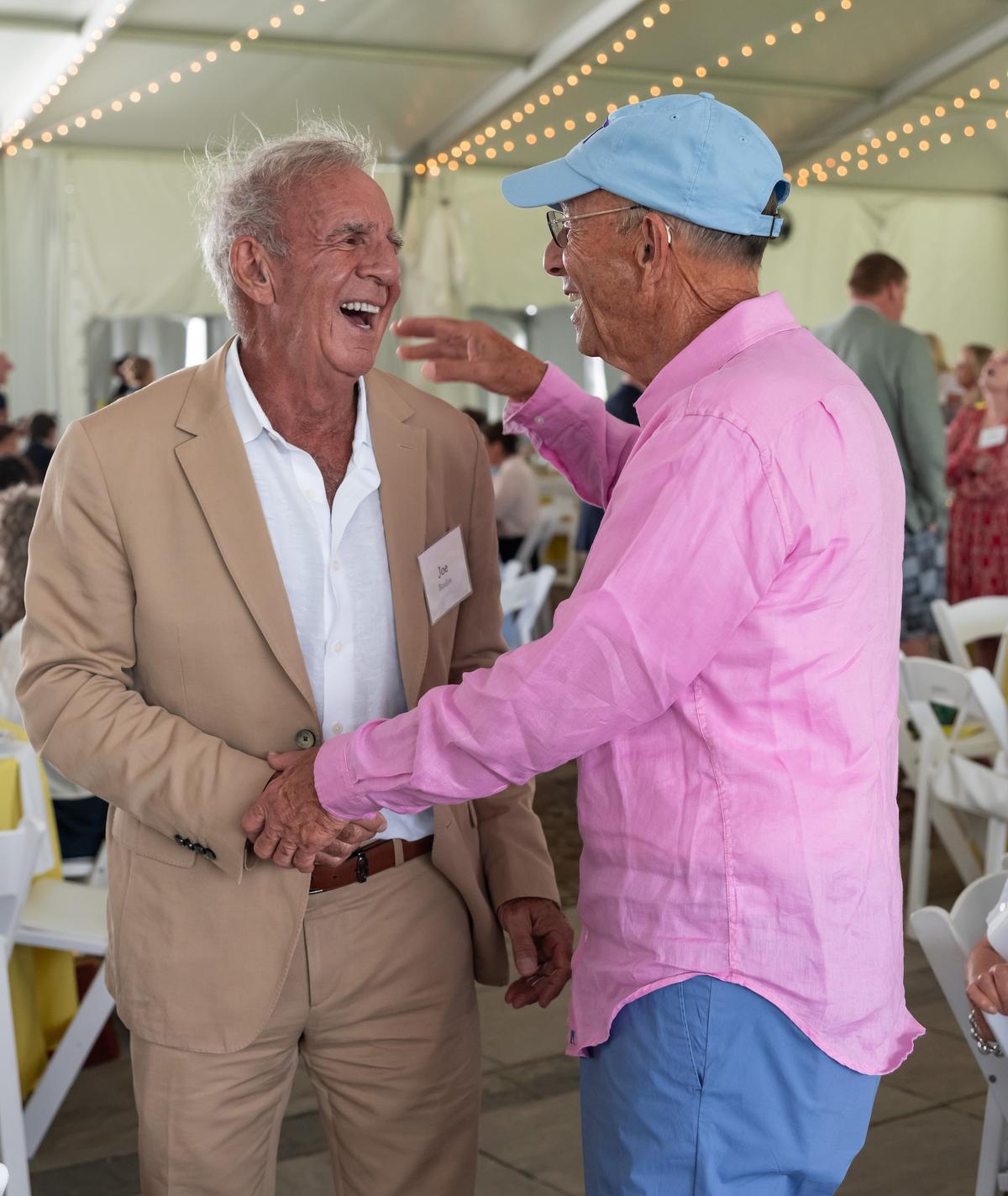 Two people enter an embrace at the Summer Luncheon.