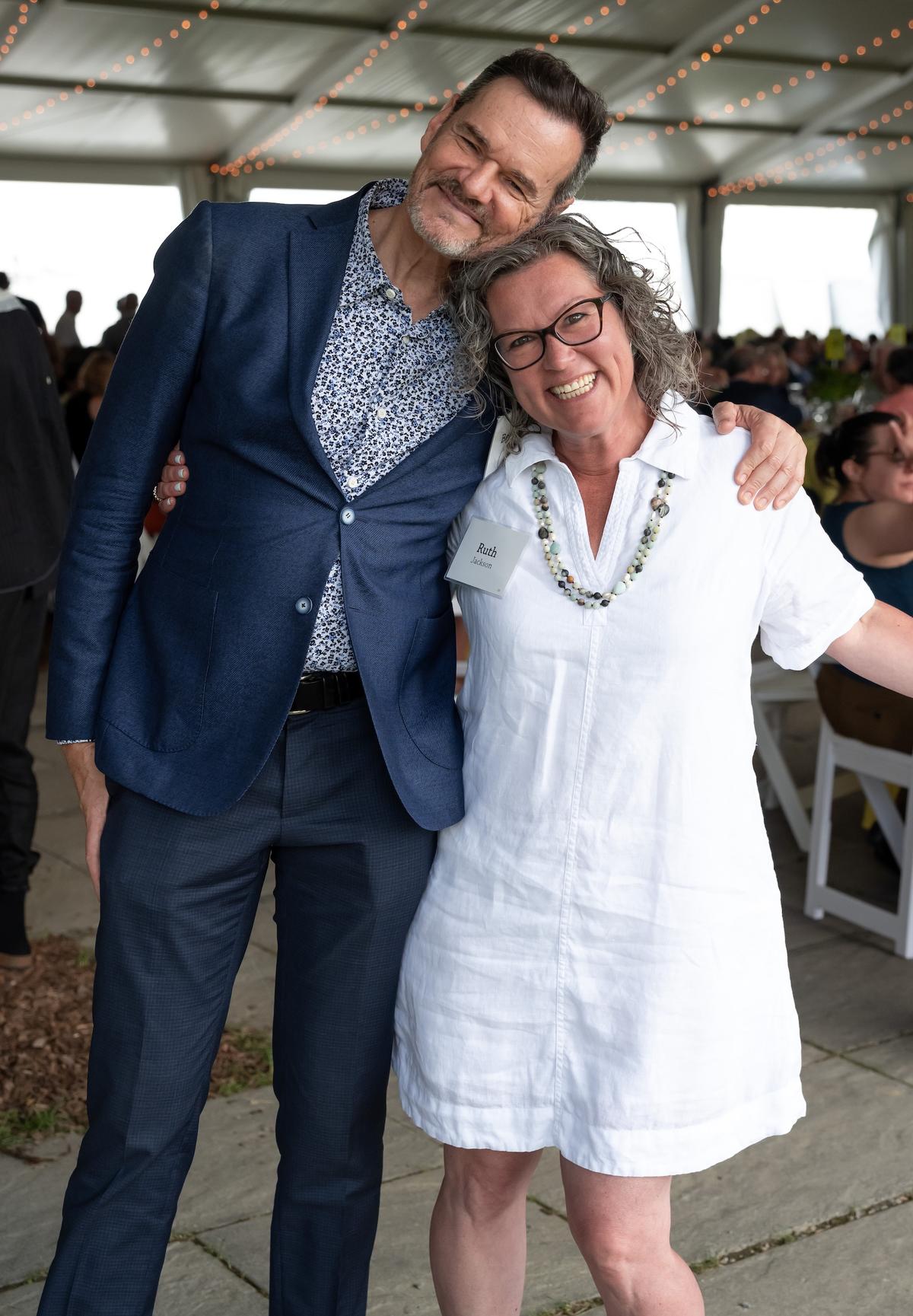 Two people smile for a photo at the Summer Luncheon.